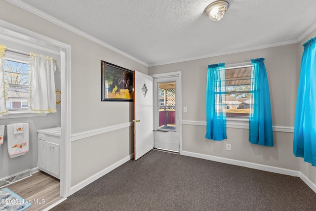 interior space featuring carpet, plenty of natural light, and crown molding