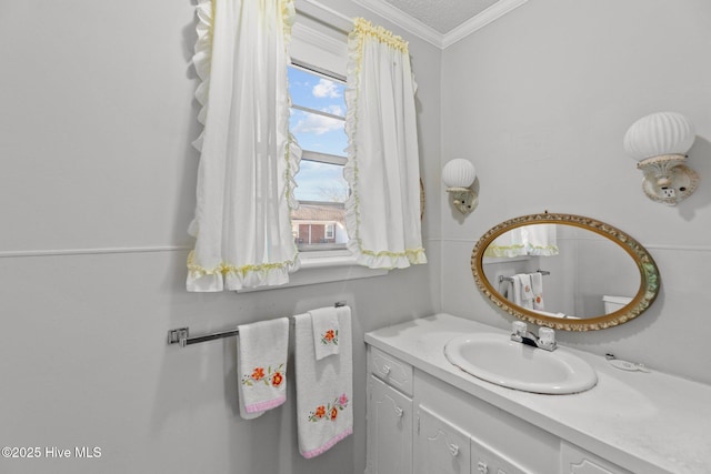 bathroom with crown molding, vanity, and a textured ceiling