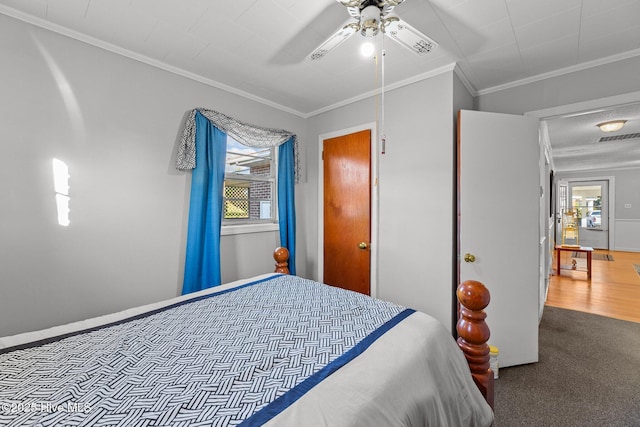 bedroom with ceiling fan, crown molding, and carpet