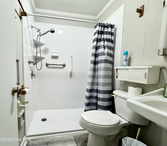 bathroom featuring a shower with curtain, toilet, ornamental molding, and wood-type flooring