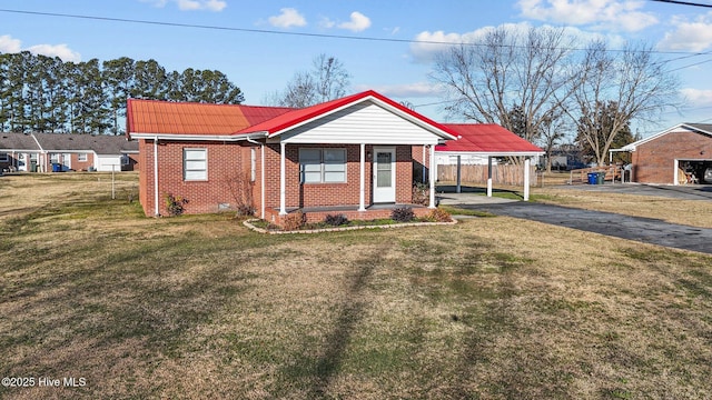 view of front facade with a front yard and a carport