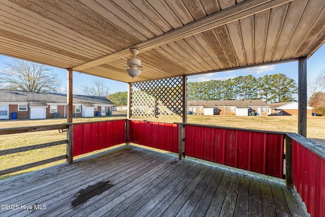 wooden terrace featuring a lawn