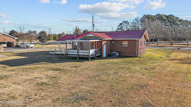 exterior space with a lawn and central air condition unit