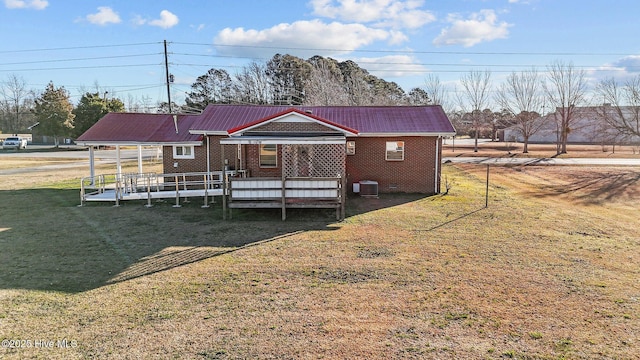 back of house with a lawn, cooling unit, and a porch