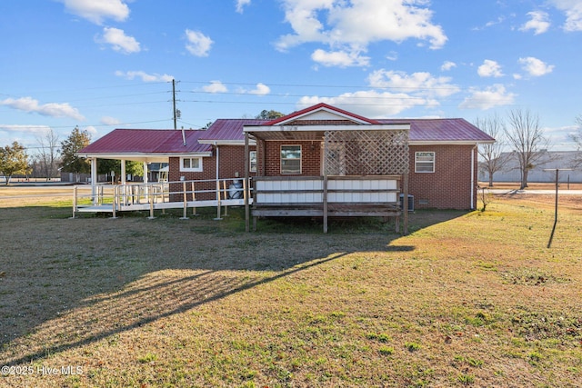 rear view of property featuring a porch, central air condition unit, and a lawn