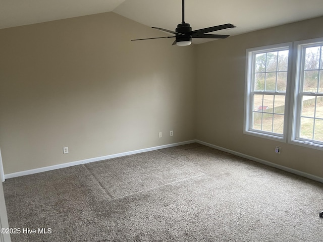 empty room featuring ceiling fan, carpet, and vaulted ceiling