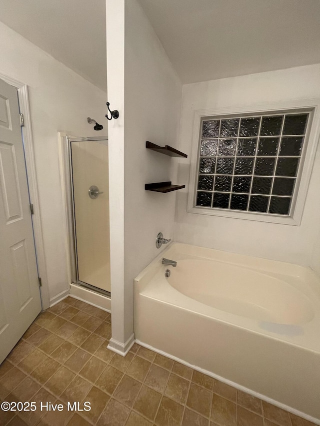 bathroom featuring separate shower and tub