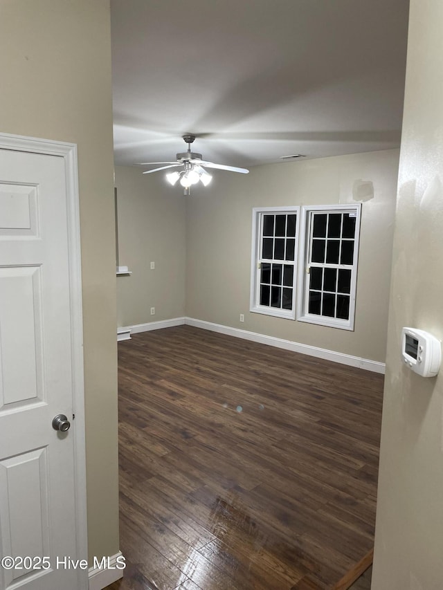 unfurnished room featuring ceiling fan and dark hardwood / wood-style floors