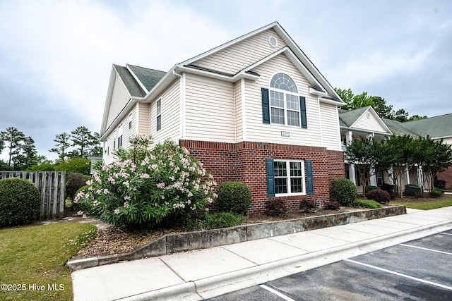 1422 Willoughby Park Ct Unit 5, Wilmington, NC 28412 - view of side of home featuring brick siding and uncovered parking