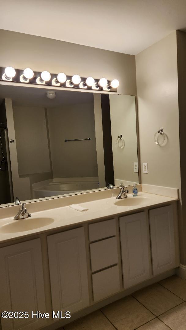 bathroom featuring tile patterned flooring and vanity