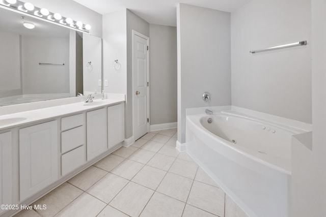 1422 Willoughby Park Ct Unit 5, Wilmington, NC 28412 - bathroom featuring double vanity, a tub with jets, tile patterned flooring, and baseboards