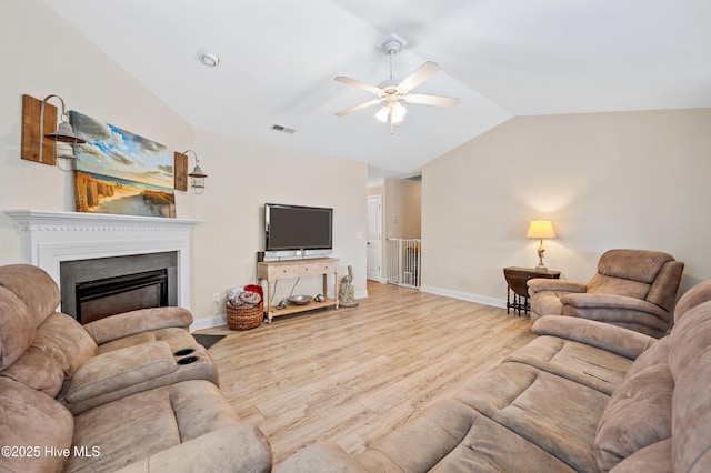 living room with vaulted ceiling, light hardwood / wood-style flooring, and ceiling fan