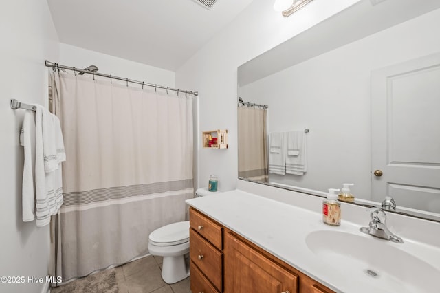 bathroom featuring tile patterned flooring, vanity, and toilet