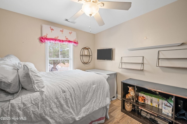 bedroom with ceiling fan and light hardwood / wood-style floors