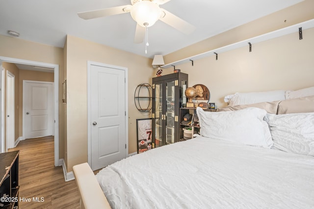 bedroom with ceiling fan and light wood-type flooring