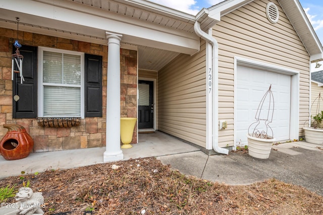 view of exterior entry with a garage