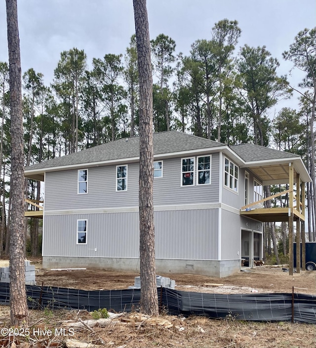 view of home's exterior featuring roof with shingles and crawl space