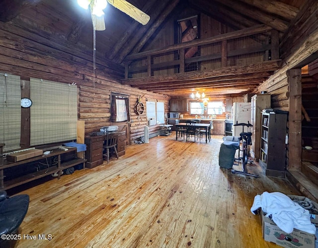 living room with beamed ceiling, ceiling fan, hardwood / wood-style flooring, rustic walls, and high vaulted ceiling