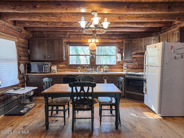 kitchen featuring light hardwood / wood-style flooring, black appliances, beam ceiling, and log walls