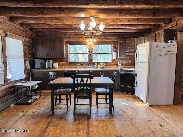 dining room with beamed ceiling, sink, rustic walls, a notable chandelier, and light hardwood / wood-style flooring