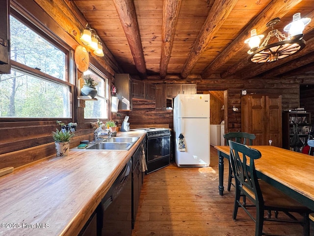 kitchen with black appliances, beamed ceiling, light hardwood / wood-style floors, rustic walls, and sink