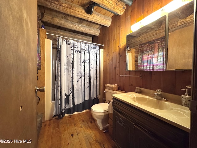 bathroom with beam ceiling, wood ceiling, hardwood / wood-style floors, vanity, and wood walls