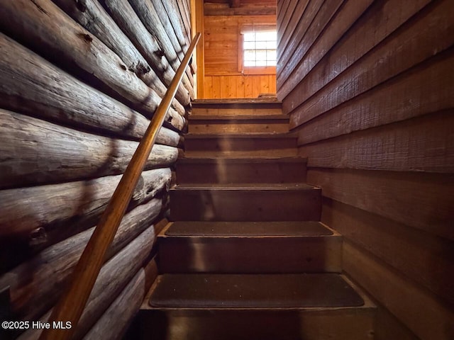 stairway featuring rustic walls