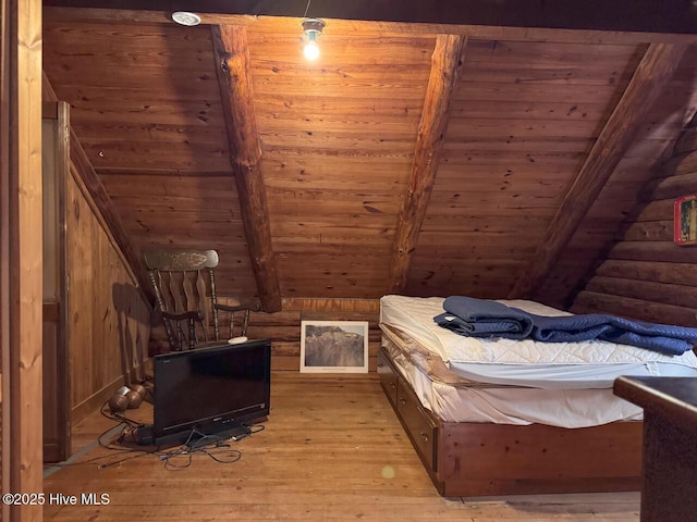 bedroom with wood ceiling, light wood-type flooring, wooden walls, and lofted ceiling with beams