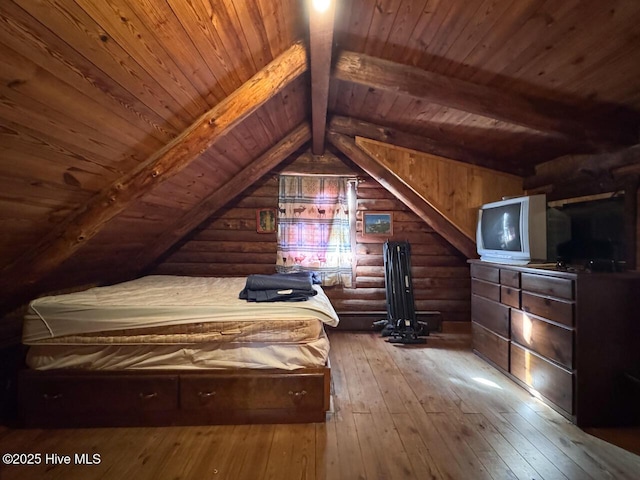 unfurnished bedroom with wooden ceiling, hardwood / wood-style flooring, rustic walls, wooden walls, and vaulted ceiling with beams