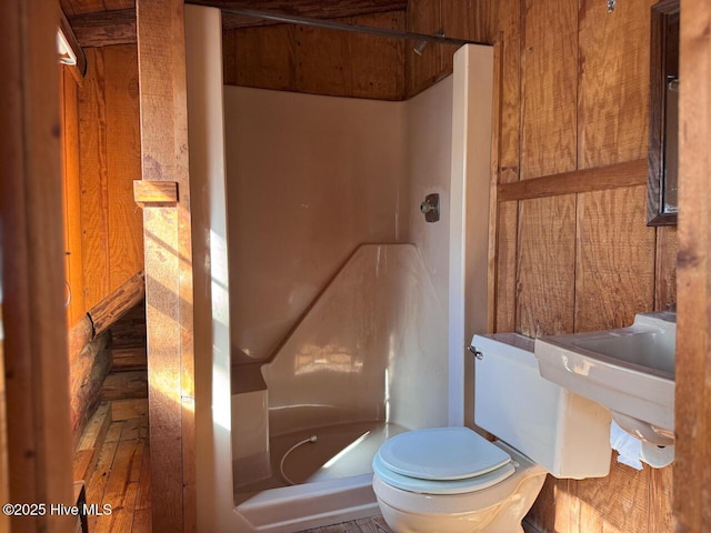 bathroom featuring sink, toilet, and walk in shower