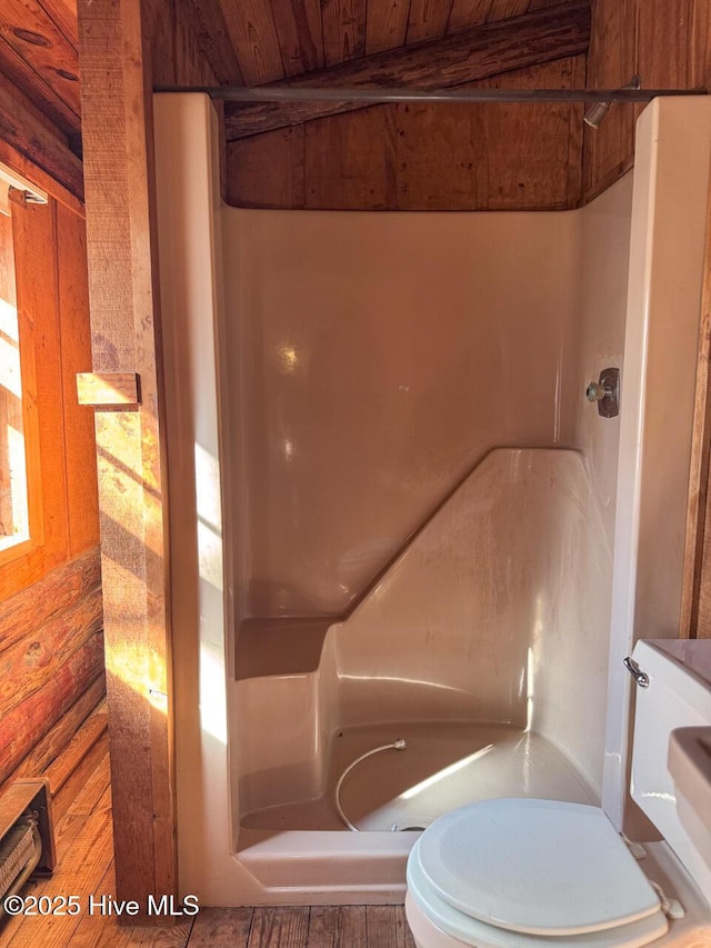 bathroom featuring a shower, wooden ceiling, toilet, and wooden walls