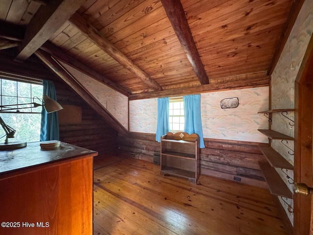 bonus room with wood-type flooring, wooden ceiling, vaulted ceiling with beams, and rustic walls