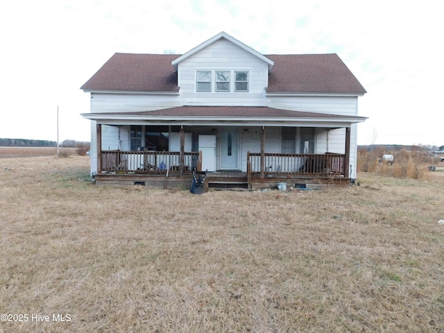 view of front of property featuring covered porch and a front yard