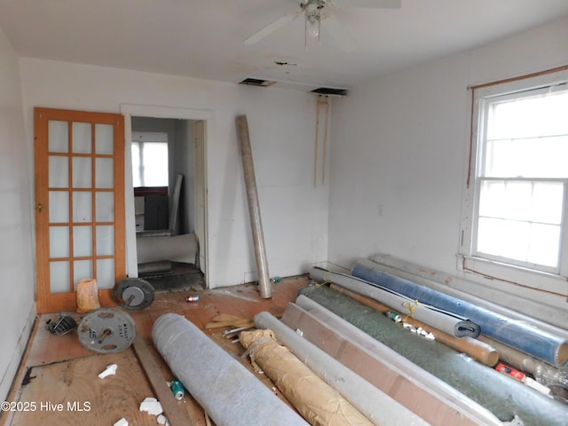 living room featuring ceiling fan and plenty of natural light