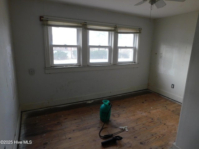 spare room featuring ceiling fan and dark hardwood / wood-style floors