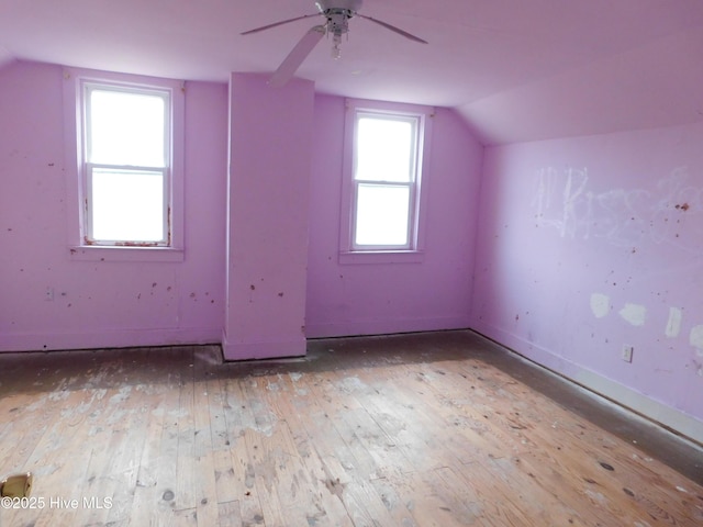 additional living space featuring ceiling fan, light hardwood / wood-style floors, lofted ceiling, and plenty of natural light