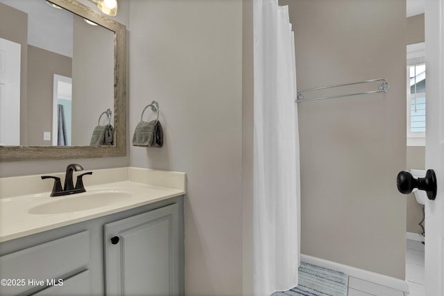 bathroom featuring tile patterned flooring and vanity