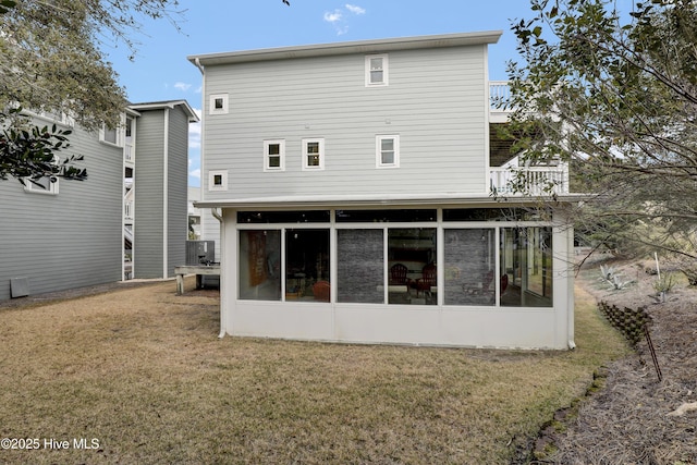 rear view of property with a yard