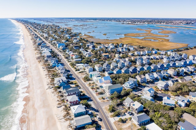 birds eye view of property featuring a beach view and a water view