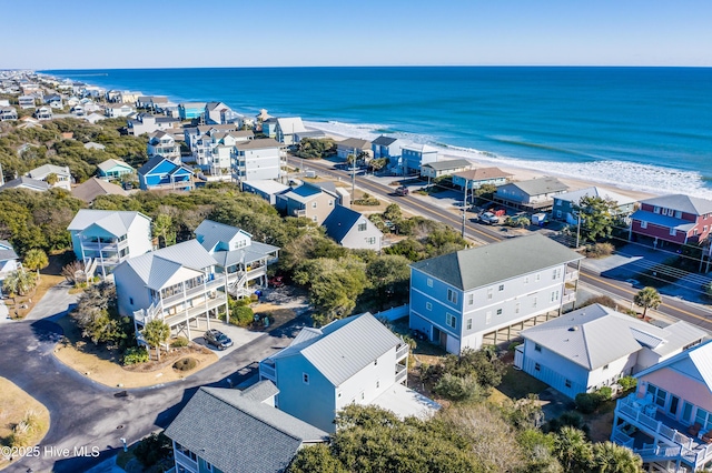 birds eye view of property with a beach view and a water view