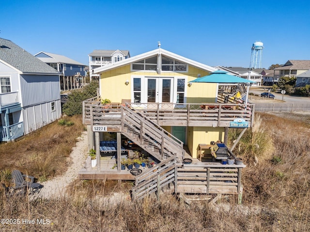 back of property featuring a wooden deck and french doors