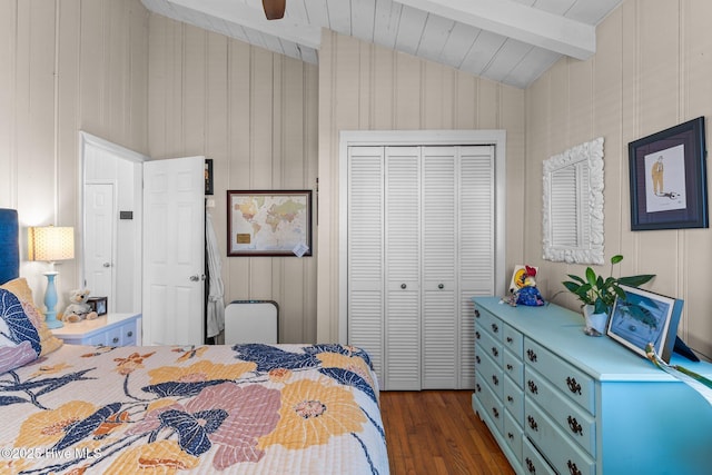 bedroom with lofted ceiling with beams, ceiling fan, dark hardwood / wood-style flooring, wood ceiling, and a closet