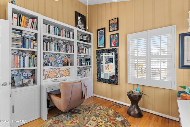 living area featuring hardwood / wood-style floors and built in features