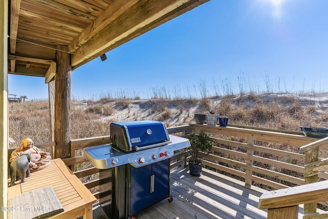 wooden terrace featuring area for grilling