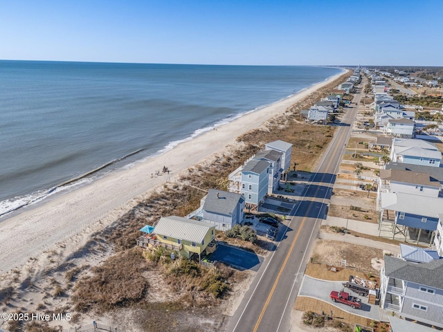 birds eye view of property with a beach view and a water view