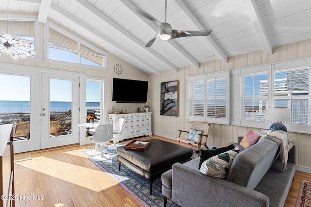 living room featuring ceiling fan, french doors, lofted ceiling with beams, and light wood-type flooring