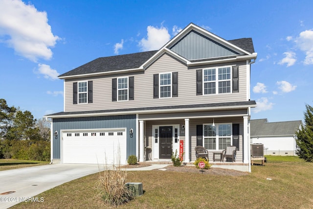 view of front of home with a porch, a garage, a front yard, and central AC