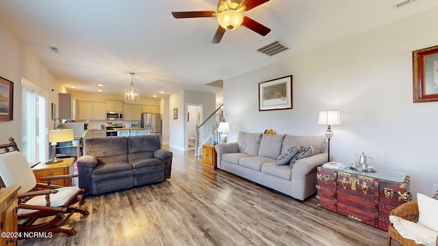 living room with ceiling fan and light hardwood / wood-style floors