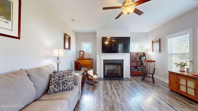 living room with a fireplace, hardwood / wood-style flooring, and ceiling fan