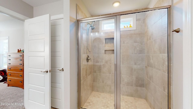 bathroom featuring a shower with door